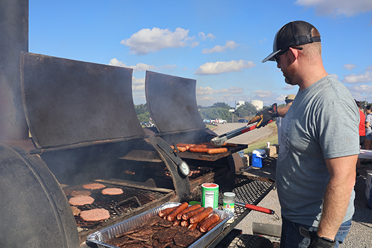 Calleb Mosburg cooking hotdogs