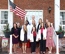 Faculty and students enrolled in the Wisdom Family Foundation Doctoral Program for Rural Nursing Practice pose for a group photo with Northwestern President Dr. Bo Hannaford outside the President’s House during residency week.  Top Row: Northwestern Oklahoma State University President Dr. Bo Hannaford.  Middle Row, left to right: Dr. Krista Tilley, Juane Russell, Michelle Milligan, Kyndall O’Donnell, Dr. Gwyneth Holderby.  Bottom Row, left to right: Dr. Sandra Watson, Alyssa Los, Tierna Adair, Sara (Garvie) Wilber, Dr. Leslie Collins.