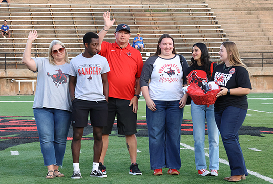 The Doug Moss Family from Irvine, California, pictured with Northwestern Scholar Ambassador member Janie Rempel (sophomore elementary education major from Forgan), far right, receive recognition for traveling the furthest distance to attend Family Day, Sept. 28.