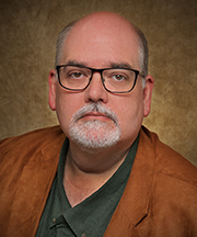 Headshot of Dr. Shawn Holliday, who is the associate dean of the Graduate Studies Program and professor of English at Northwestern Oklahoma State University.