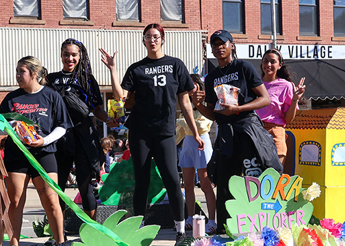 Hispanic American Leadership Organization (HALO) members pose for a picture in between tossing candy to parade attendees. HALO members and their “Dora the Explorer” float won the President’s Award for best overall float.