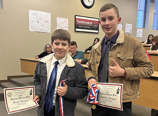 image of Wyatt and Maddox Morgan holding their certificates