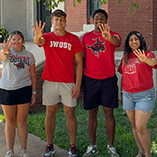 Students holding up four fingers in honor of four consecutive years of no tuition increase. 