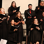 NWOSU choir performing on stage in Herod Hall