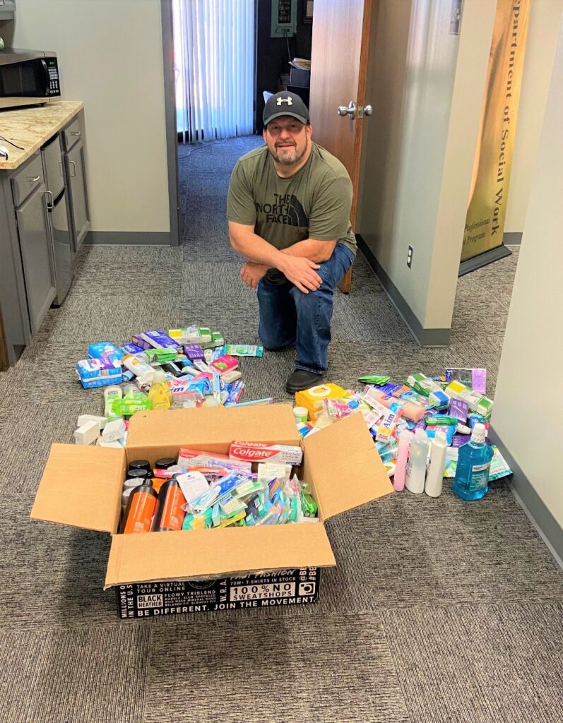 Scott Messenger, Enid senior and SWAT Enid campus vice president, separating the donations to disperse to all three campuses.