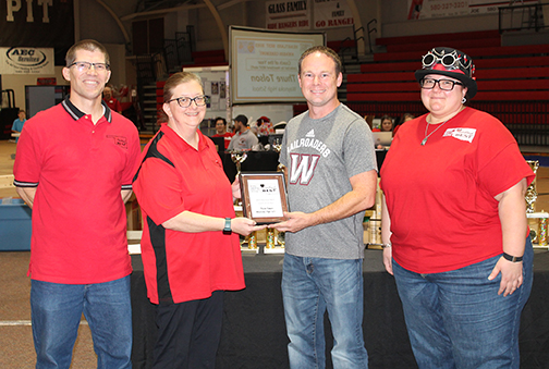 Thure Tolson, coach of the Waynoka High School robotics team (second from right), is awarded Coach of the Year by Heartland BEST director Dr. Tim Maharry (far left), and co-directors Dr. Jenny Sattler (left) and Dr. Mary Riegel.