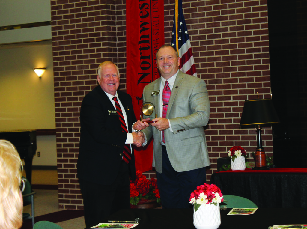 Dr. Jerry Gustafson is all smiles after receiving his 25-year service award from Northwestern President Dr. Bo Hannaford.