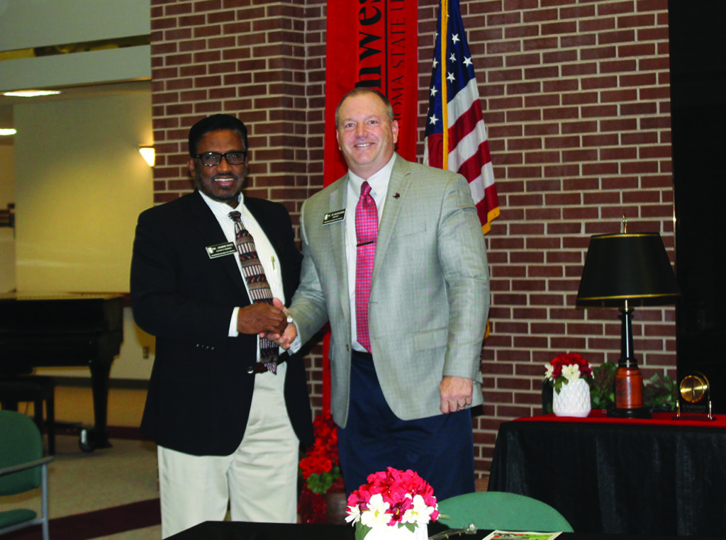 Dr. Joseph Paul receives his five-year service award from Northwestern President Dr. Bo Hannaford at the Northwestern-Enid ceremony.