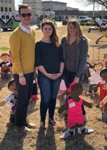 Pictured are (left to right) Levi Sanders, Goltry senior, SWAT president; Annie Moss, Enid senior, SWAT member; and Sierra Miller, Enid senior, SWAT secretary, with the “Wooden Children” at the Garfield County Courthouse.