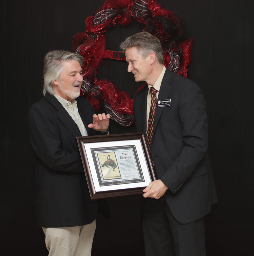 (Left) Max Ridgway, adjunct instructor of music, is presented with the Outstanding Adjunct Faculty Member of the Year award from Dr. Steven Maier, dean of faculty.