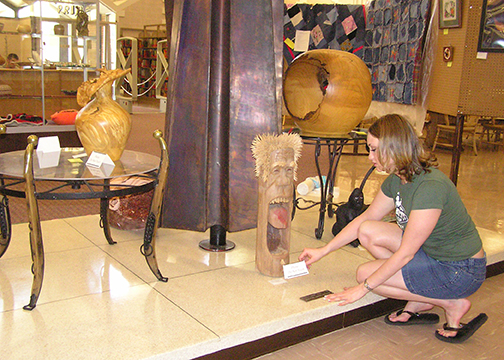 Christa Evans (now Rogers) helps set up the first campus art show in April 2004 for what was originally named Student Advocates for the Arts. The name changed to NWOSU Art Society the next year.