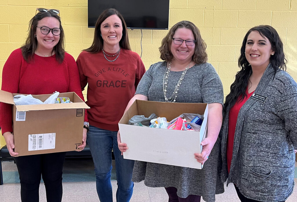 Alva Middle School receives donations from the Northwestern Oklahoma State University SWAT Compassion in Action Dignity Drive. (Left to right) Bishop Buck, SWAT vice president, Jaci Heaton, Alva Middle School counselor, Ashley Garner, SWAT president, with Codi Harding, SWAT sponsor and assistant professor of social work.