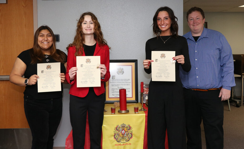 (Left to right) Kimberly Guel, Ava Carr, M’Cheila Rader and Northwestern chapter sponsor Dr. Robert Vest gathered for the induction ceremony for Sigma Delta Pi, a national Hispanic honor society.